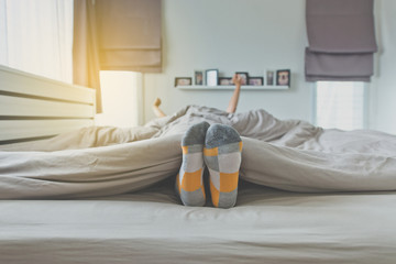 Foot on the bed focus feet with socks,Feet and stretch lazily after waking up