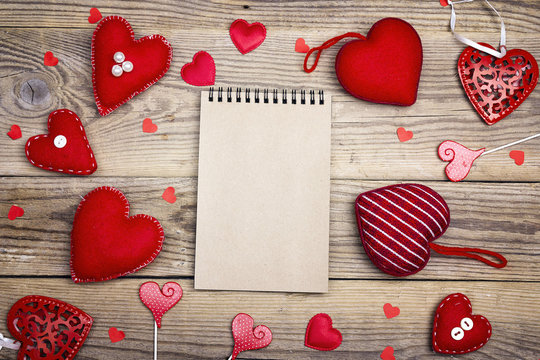Open blank notebook  with Valentine hearts on old wooden background. Copy space. Valentines day background.