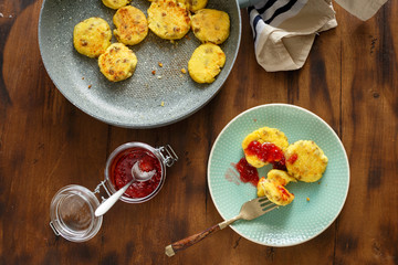 Homemade cheese pancakes on wooden table jar of raspberry jam
