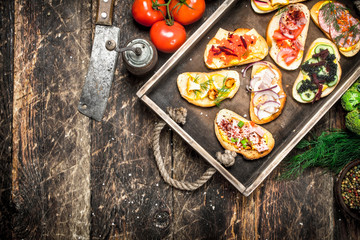 Sandwiches with seafood, salami, bacon and fresh vegetables.