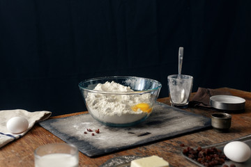 Ingredients for cooking Easter homemade cross buns on wooden table