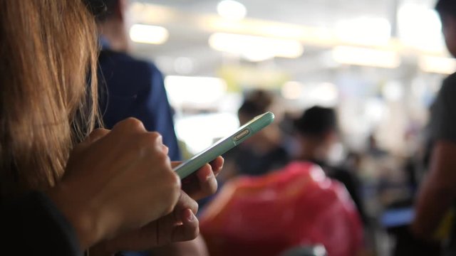 Tourist Woman in Airport Check-in Queue Using Mobile Smart Phone. 4K, Close Up Travel Technology Concept.