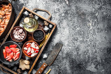 Different seafood on a wooden tray.