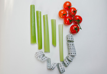 celery, tomatoes and tape on a white background