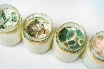 Yogurt with mold in glass container in laboratory