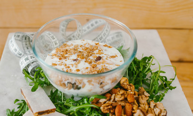 A healthy breakfast. Muesli with milk, walnuts and lettuce