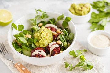 Green vegetable vegan salad with beets meatballs, Guacamole and tahini dressing. Healthy vegetarian food concept. Copy space