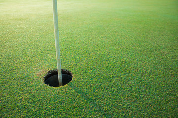 golf hole on a field in the morning at golf course