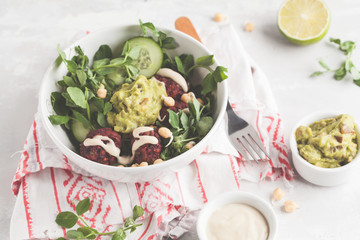 Green vegetable vegan salad with beets meatballs, Guacamole and tahini dressing. Healthy vegetarian food concept. Copy space