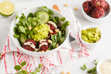 Green vegetable vegan salad with beets meatballs, Guacamole and tahini dressing. Healthy vegetarian food concept. Copy space