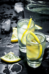 Vodka in glasses with lemon and ice.