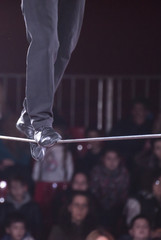 A man walks in a rope in a circus