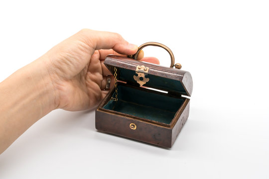 Hand opening vintage luxury wooden box with gold lock and handle isolated on white