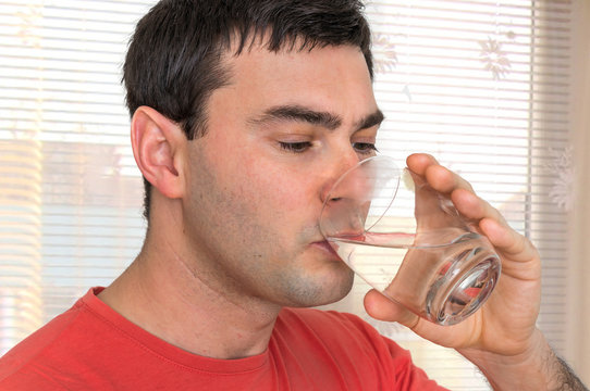 Young man drinking fresh water