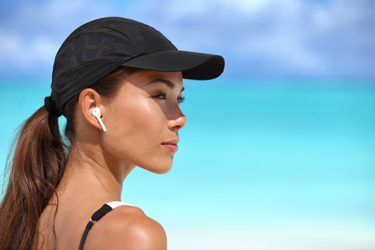 Wireless earbuds running woman on fitness workout