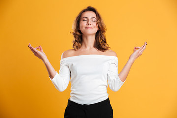 Concentrated young woman meditate.