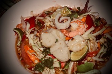 Seafood salad on a plate on the table.