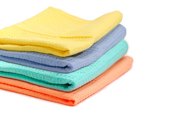 Set of folded multicolored waffle towels closeup with selective focus