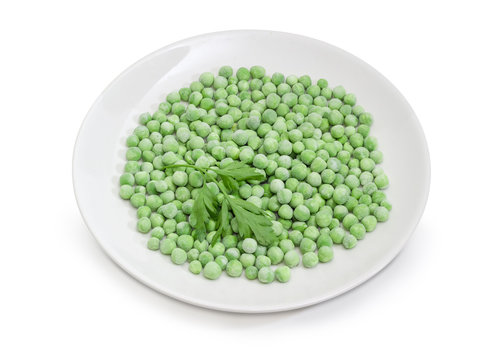 Frozen green peas on dish on a white background