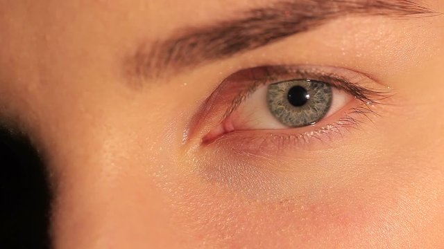 Natural female eye with  pupil and eyelashes. Macro studio shot
