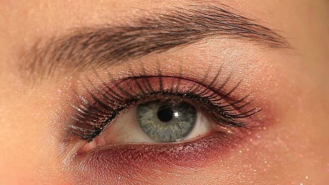 Female eye with  mascara ,pupil and eyelashes. Macro studio shot