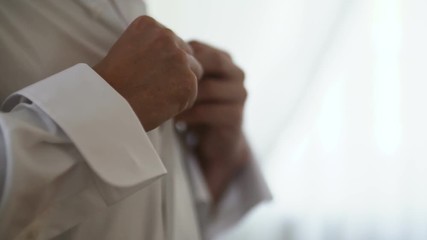 Man buttoning shirt closeup. Dressed man. Dressing up men's. Men hand wearing shirt