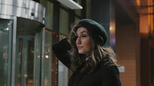 Girl tourist looking around in a night city