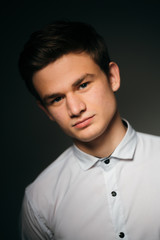 young brunette guy in a white shirt