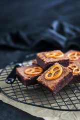 Homemade chocolate brownies with salted pretzels on top