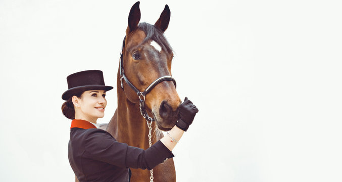 Rider Elegant Woman Talking To Her Horse. Portrait Of Riding Horse With Woman In Hat. Equestrian Horse With Rider And Old Stable In Background. 