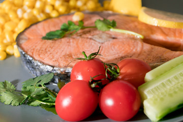 fresh tomato on the grilled fish salmon fillet  dish, food and vegetable concept