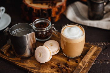 Close-up of coffee with milky foam, macaroons. Breakfast Arrangement