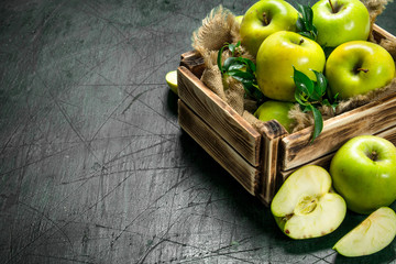 Green apples in an old box.