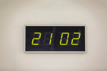 Black digital clock on a white background showing time 21 02