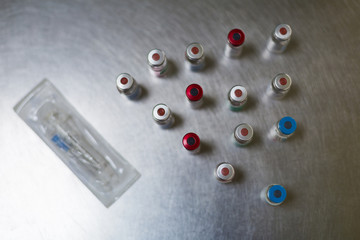 Vaccine vials with syringe