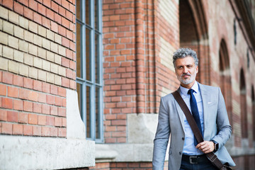 Mature businessman walking in a city.