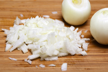Fototapeta na wymiar Onion and onion slices on wooden cutting board.