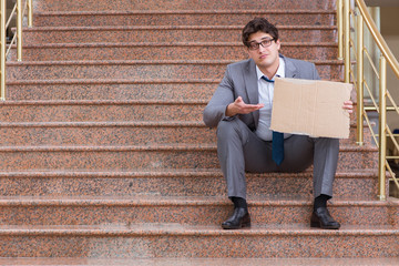 Desperate businessman begging on the street