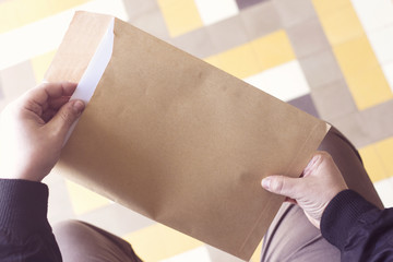 Hand opening brown Document Envelope with copy space