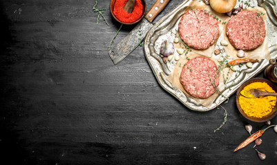 Fototapeta na wymiar Raw burger with garlic and spices on a steel tray.