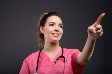 Portrait of beautiful young doctor using touchscreen