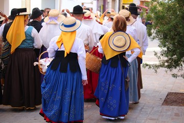 Locals in traditional dresses at a public Canarian festival (La Gomera, Spain)