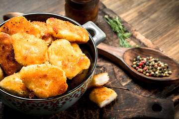 Fresh chicken nuggets with sauce and spices.