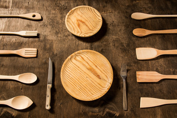 Wooden kitchen utensils on rustic background.