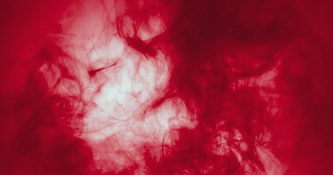 red paint floating in water like smoke cloud