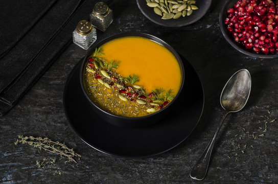 Pumpkin and carrot soup decorated with pomegranate arils, chia seeds,crunchy pumpkin seeds,chopped dill and a sprinkle of freshly ground black pepper