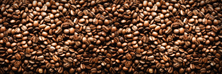 Roasted coffee beans backgound, copy space, top view. Cappuccino, dark espresso, aroma black...