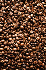 Roasted coffee beans backgound, copy space, top view. Cappuccino, dark espresso, aroma black caffeine drink, ingredient for coffee beverage.