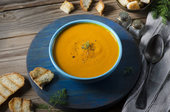 Roasted Pumpkin Apple Soup served with roasted bread and topped with a sprinkle of freshly ground black pepper