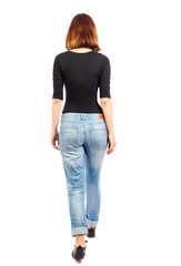 Obraz premium back view of walking woman.
